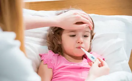Toddler with a thermometer