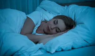 אישה ישנה על מיטה
