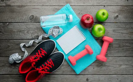 Sports shoes, a towel and three apples