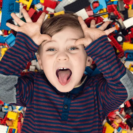 A boy on a pile of legos
