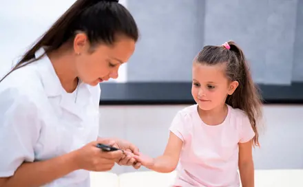 A girl taking a blood test from her finger