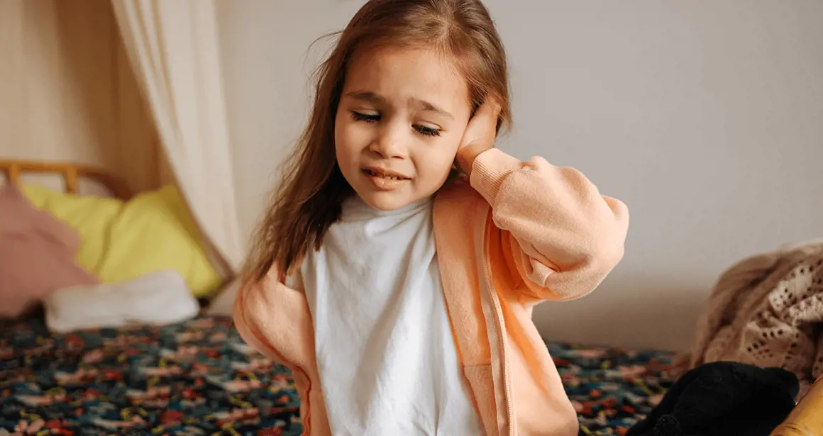 A girl who has a pain in her left ear