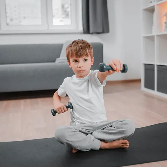 A boy lifts weights