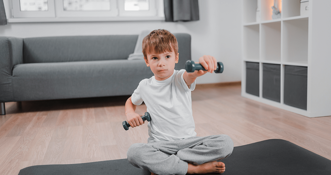 A boy lifts weights