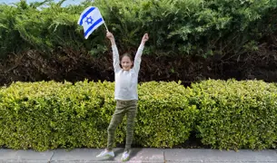 ילדה מניפה דגל ישראל